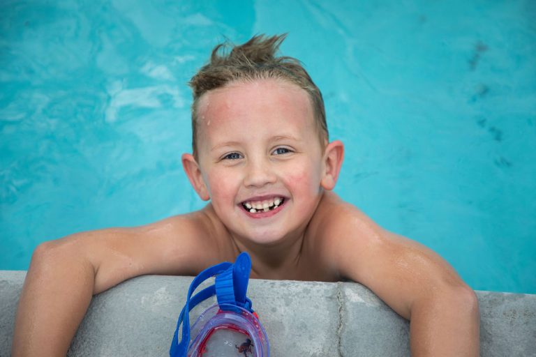 kid in blue pool