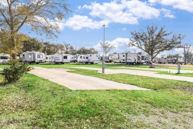 Vinton LA RV Park Vinton LA RV Park in Vinton, Texas features parked RVs, open sunny campground, concrete pads, green grass, trees, and blue sky.