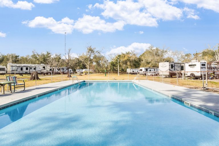 Vinton LA RV Park Vinton LA RV Park in Vinton, Texas features a clear outdoor swimming pool, concrete deck, fenced area, and RVs on grassy lots.